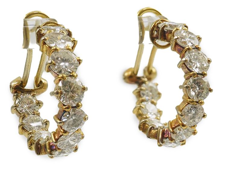 A modern pair of 18ct gold and graduated eleven stone round brilliant cut diamond set hoop earrings